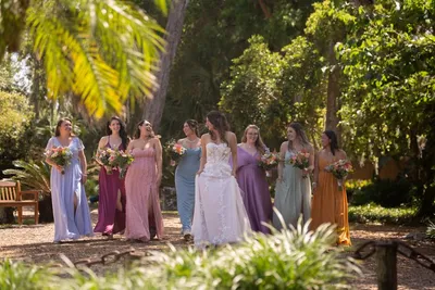 First kiss at outdoor ceremony under palm trees at Fountain of Youth with marsh backdrop