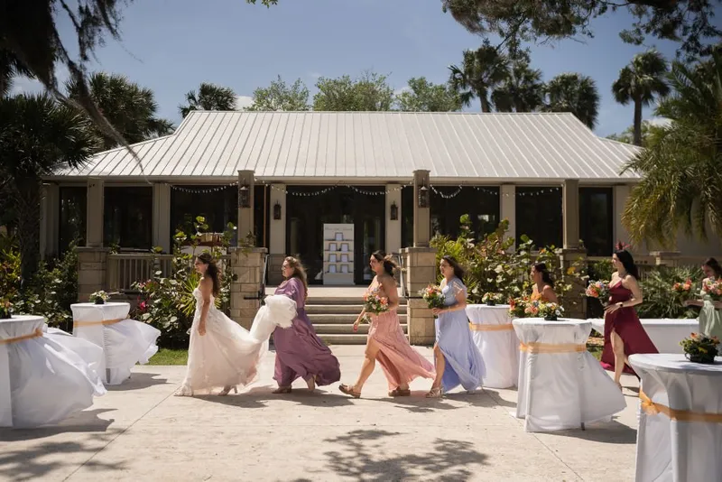 Bride and bridesmaids in colorful mismatched dresses walking at Fountain of Youth