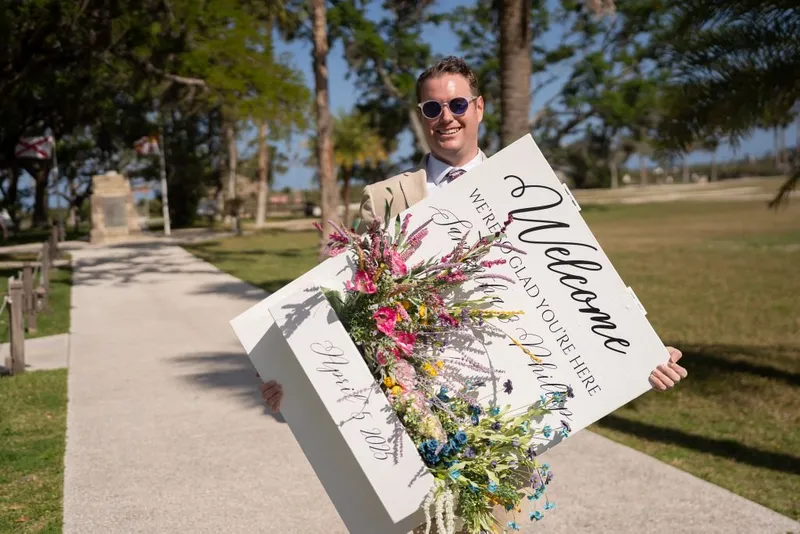 Groom with welcome sign at Fountain of Youth wedding