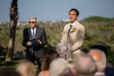 Groom waiting at altar with marsh backdrop at Fountain of Youth ceremony