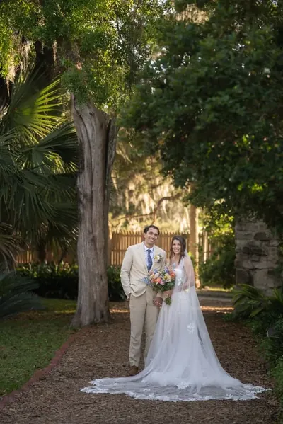 Bride and groom portrait in lush garden at Fountain of Youth with Spanish moss
