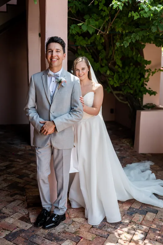 Nathan and Sarah stand together outside at The White Room, moments before walking down the aisle.