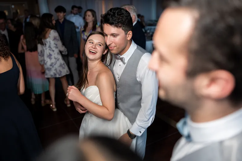 A person in a white gown and another in a gray vest dance together at The White Room, St. Augustine.