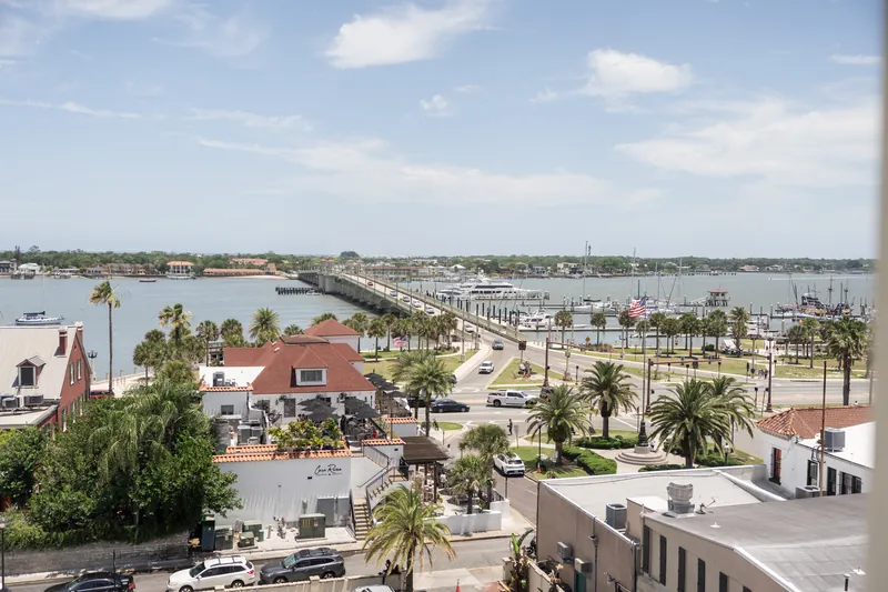 Aerial view of St. Augustine's waterfront showing the Castillo de San Marcos, marina, palm-lined streets, and bay