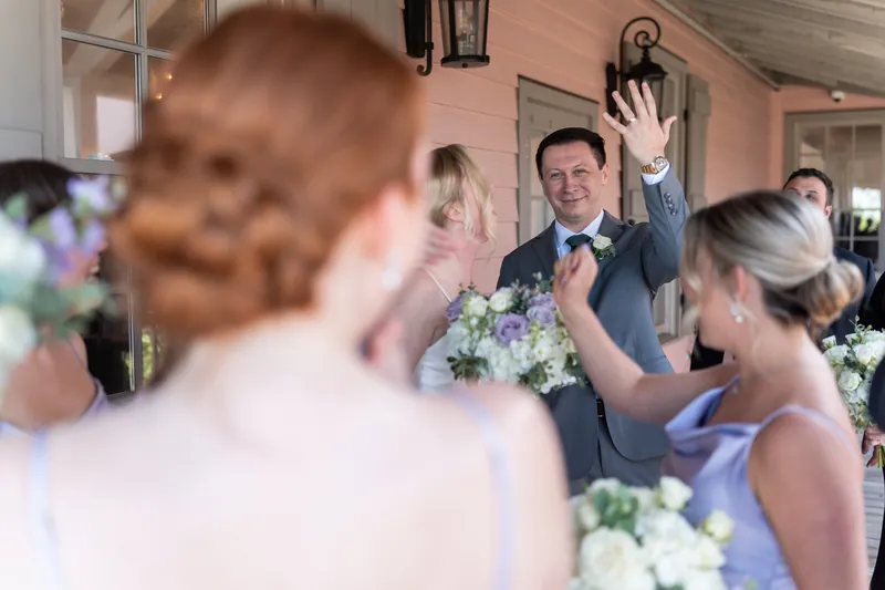 Tim waves to guests during the reception while Sarah and attendees look on and celebrate.