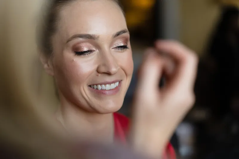 Simone smiles warmly while getting her makeup applied at Casa Monica Resort & Spa.