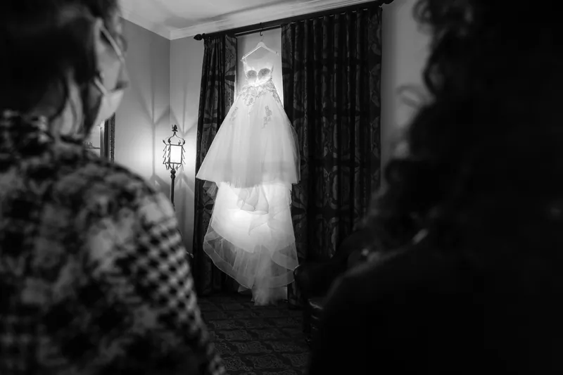 Attendants admire the hanging wedding dress in black and white at Casa Monica Resort & Spa.