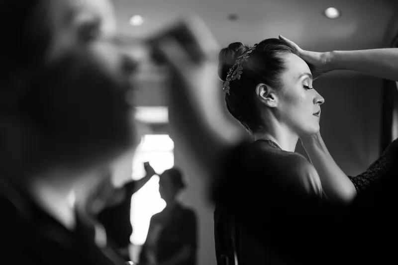 Simone fastens her hair accessory in profile during getting-ready moments.