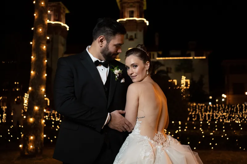 Michael and Simone embrace under warm lights strung around the Spanish colonial arches of Casa Monica Resort & Spa.