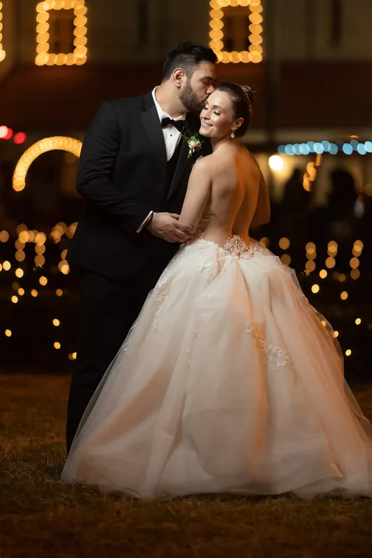 Simone's peach tulle gown flows around her as Michael holds her hand during an evening dance.