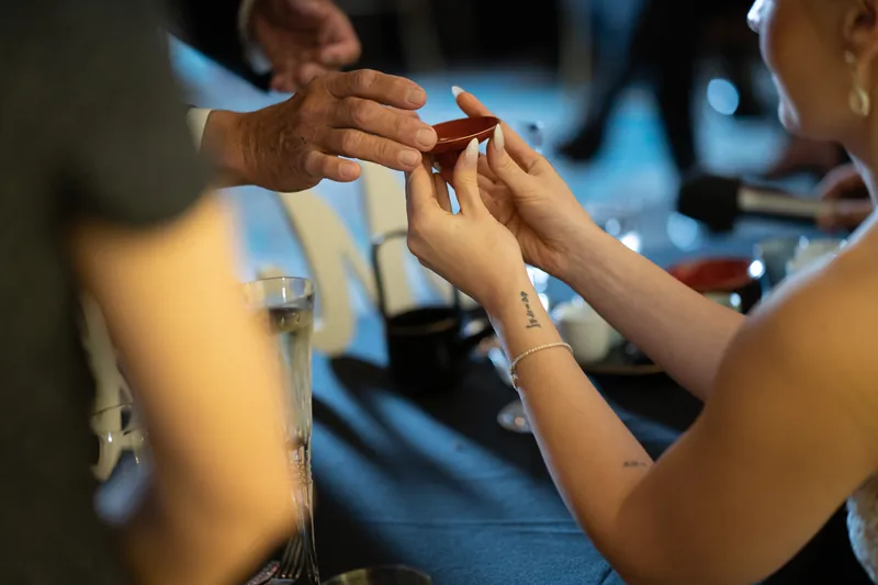 Michael and Simone exchange rings at Casa Monica Resort & Spa, their hands meeting as they complete the ceremony.