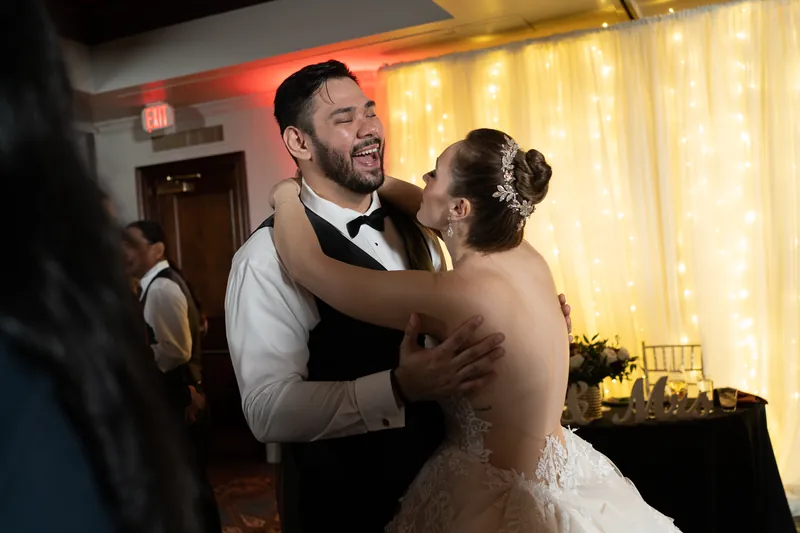Michael and Simone embrace during their first dance in formal wedding attire.