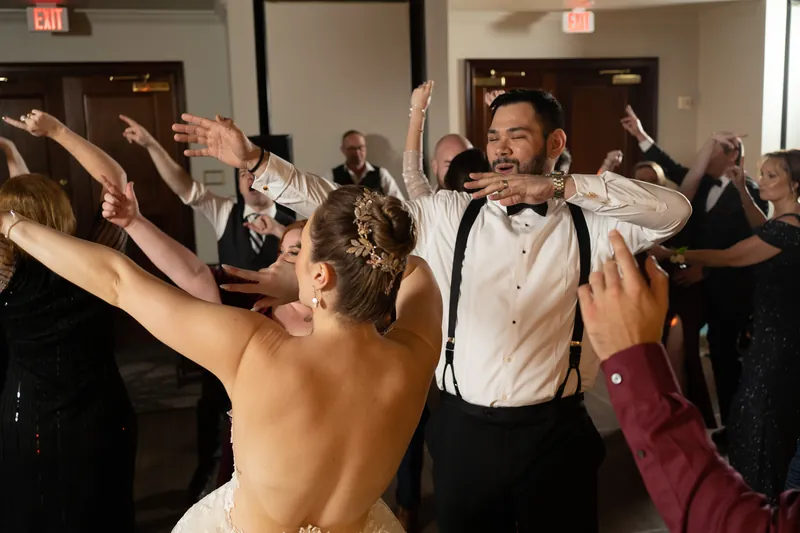 Simone and Michael dance together at Casa Monica Resort & Spa while guests around them raise their arms and celebrate.