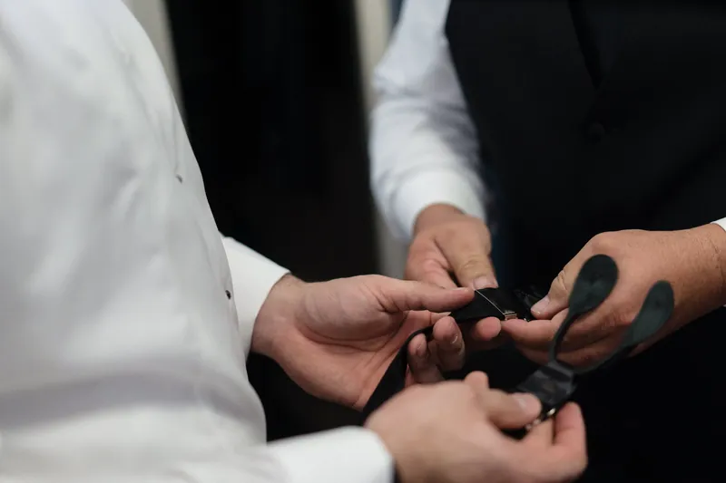 Simone and Michael exchange rings during their ceremony, their hands meeting as they hold the bands.
