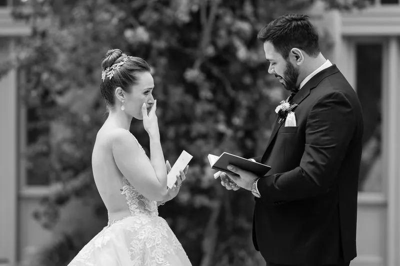 Simone holds Michael's hands while exchanging vows in a black-and-white ceremony moment at Casa Monica Resort & Spa.