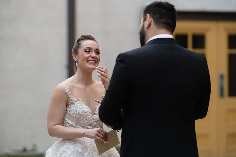 Simone gazes at Michael while holding his arm in front of the resort's Spanish colonial architecture and yellow wooden doors.