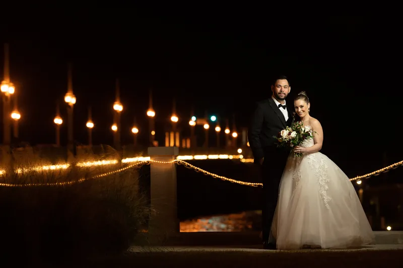 Michael and Simone stand together on an illuminated pathway lined with hanging lights at Casa Monica Resort & Spa.