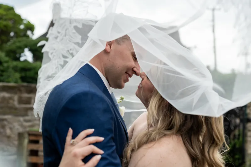 Elliot and Skye kiss under her veil during an intimate moment on their wedding day.