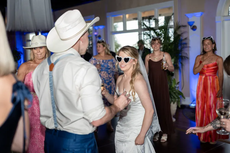 Skye dances with a guest wearing a cowboy hat during the evening reception.