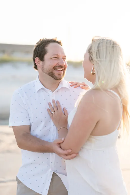 Paige shows off her new ring while embracing Steve on the sandy shore.