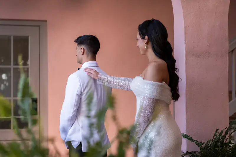 Tayler touching Jay's shoulder from behind during first look