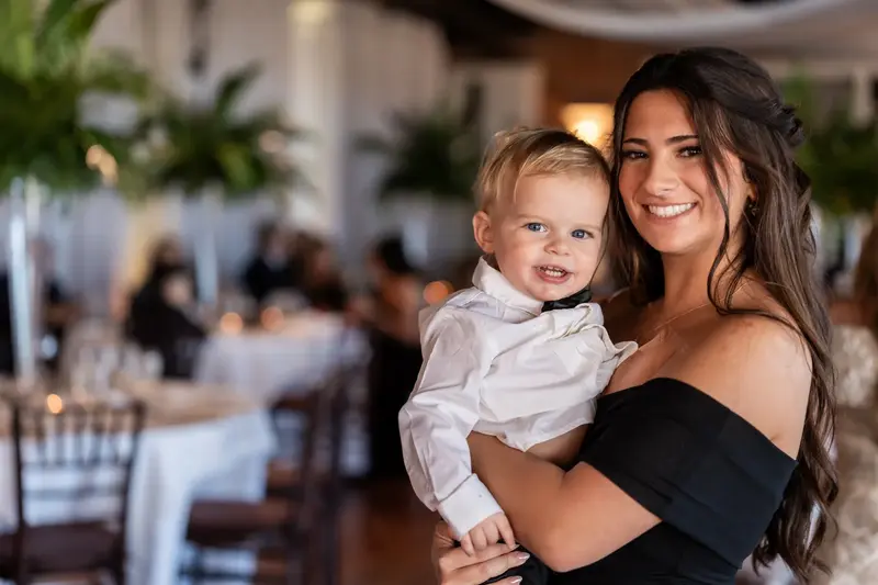 Bridesmaid holding baby Gemma at the reception