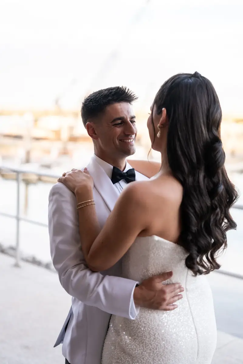 Couple portrait on rooftop with bright sky background
