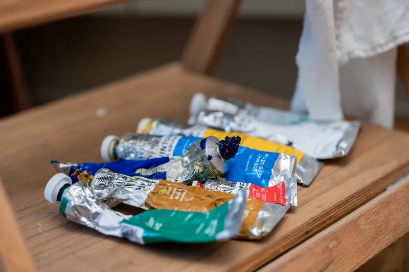 Colorful markers and supplies lie scattered on a wooden table at River House Events, St. Augustine.