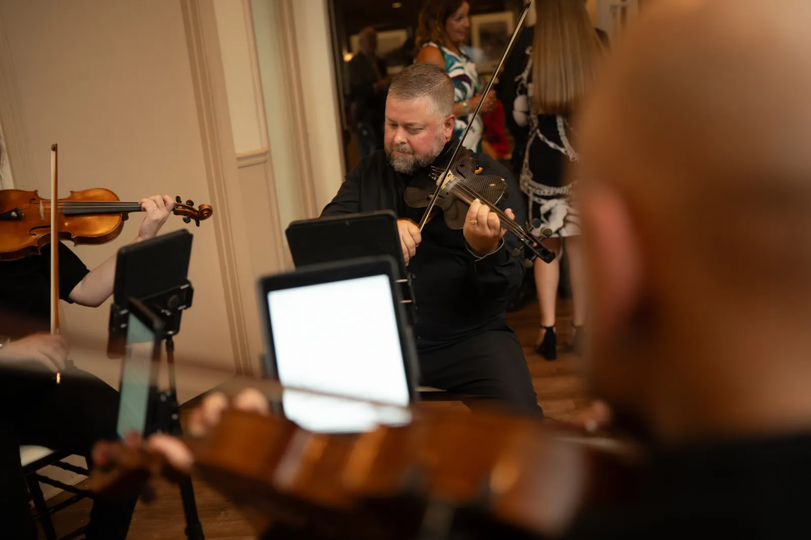 A Wehner Weddings violinist performing live during a wedding reception.