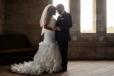 Romantic couple silhouette backlit by gothic windows at Castle Ottis wedding venue St. Augustine