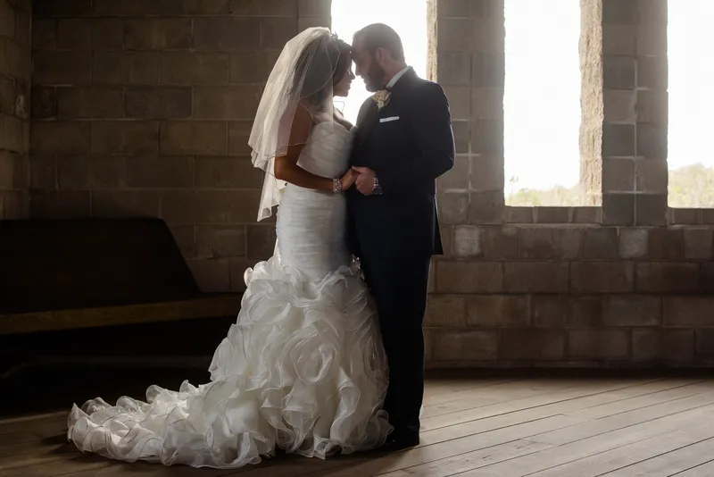 Romantic couple silhouette backlit by gothic windows at Castle Ottis wedding venue St. Augustine