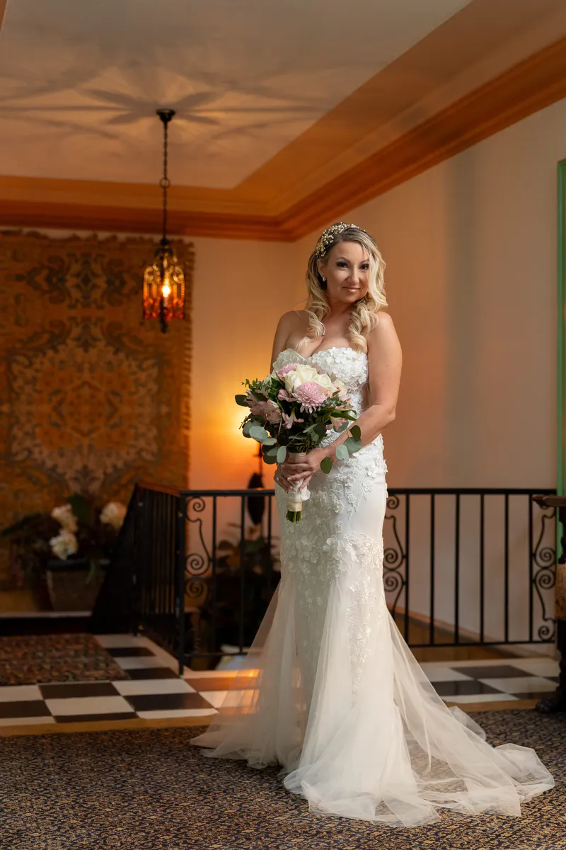 Bride portrait in the Mira Rio mansion at Club Continental with checkered marble floor and wrought iron railing