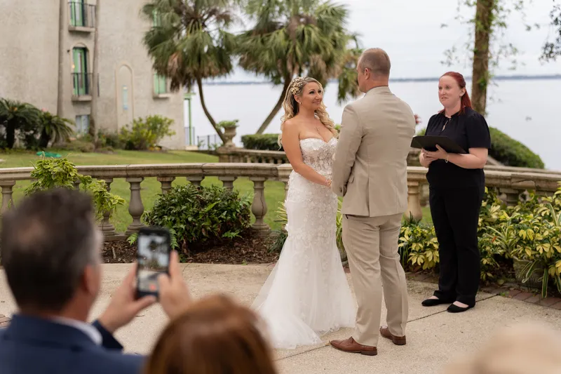 Wedding ceremony on the riverfront lawn at Club Continental with the St. Johns River and mansion in the background