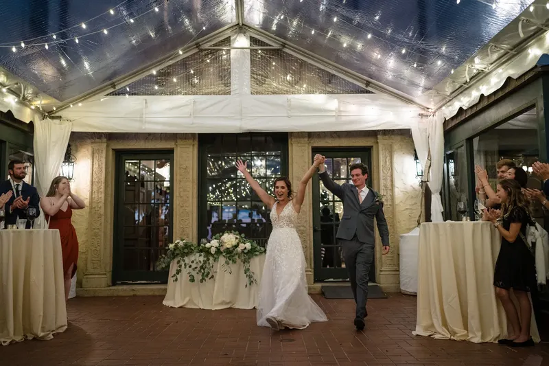 Grand entrance at wedding reception under clear tent at Epping Forest