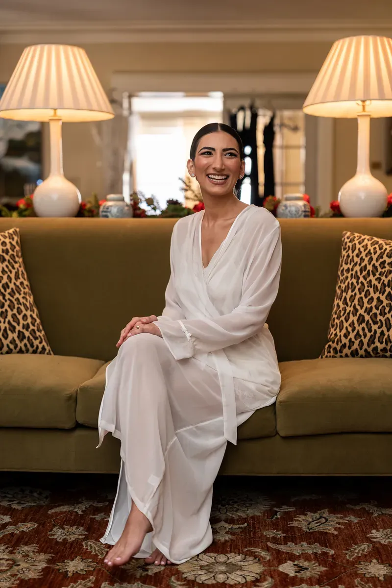 Bride in white robe during getting ready at Flagler College bridal suite