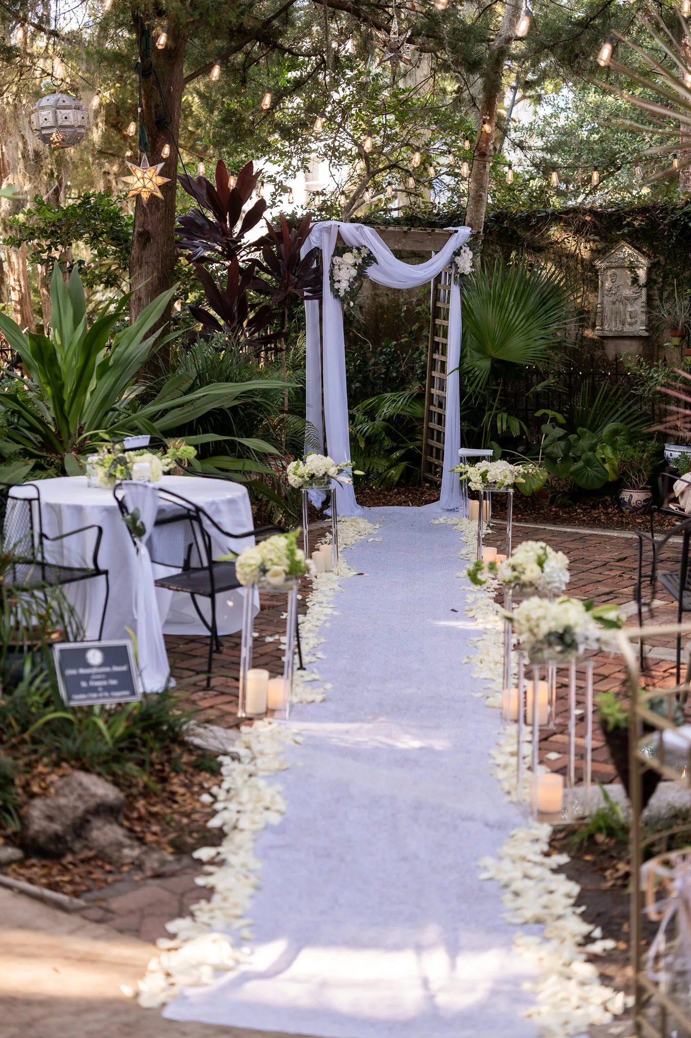 St Francis Inn courtyard ceremony setup with white draping and candles