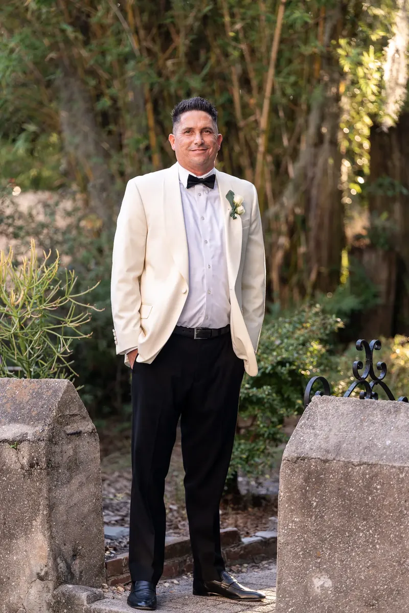 Groom portrait in the lush garden at St Francis Inn