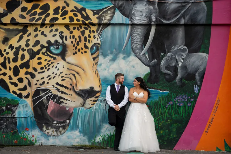 Wedding couple portrait at colorful jaguar mural in Jacksonville