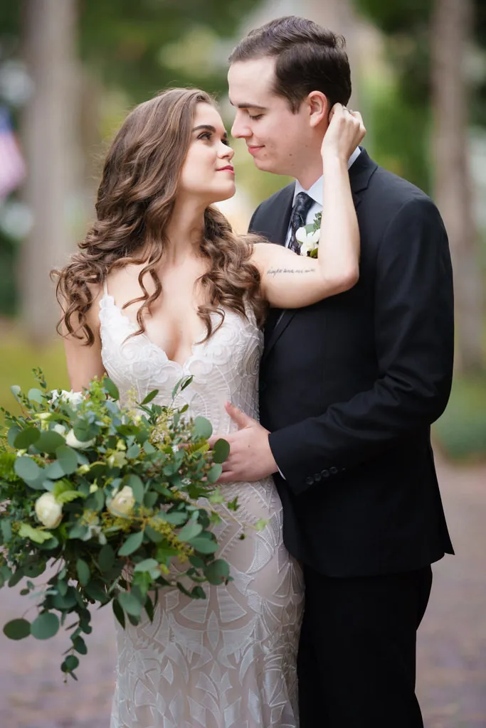 Bride and groom embrace in romantic couples portrait