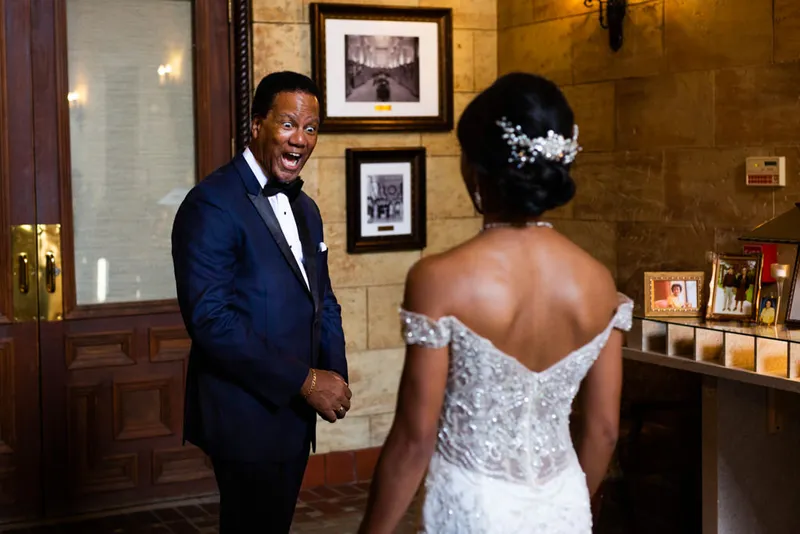 Father's emotional reaction seeing bride in wedding dress