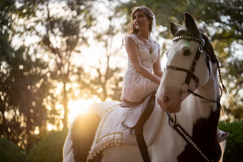 Bride riding horse into wedding ceremony in St Augustine