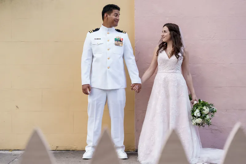 Military groom in navy uniform with bride