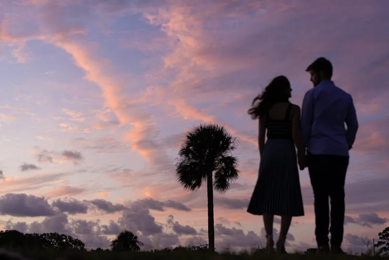 St Augustine sunset engagement session couple watching palm tree
