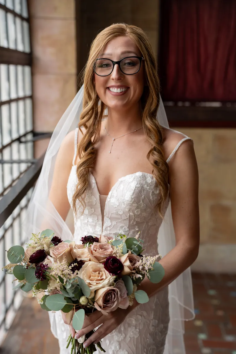 Smiling bride with dusty rose bouquet at Treasury wedding