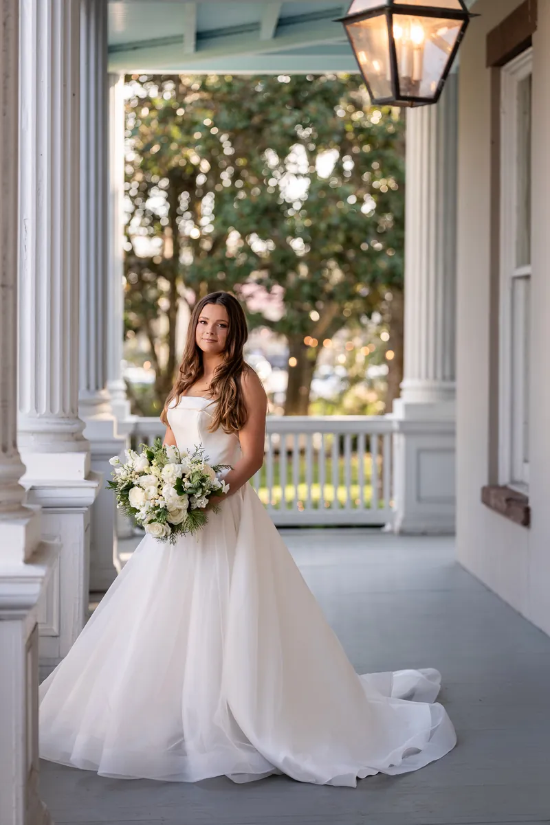 Bridal portrait on historic Southern porch with columns