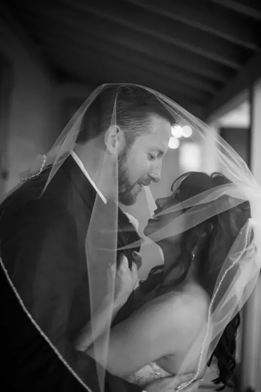 Intimate bride and groom moment under veil at The White Room
