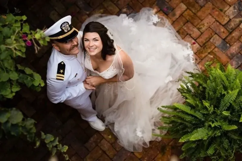 Naval officer and bride in champagne courtyard at The White Room St Augustine