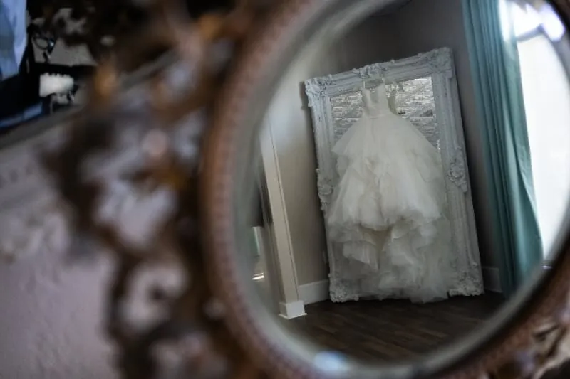 Wedding dress in ornate mirror at The White Room St. Augustine
