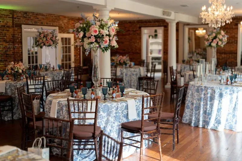 Wedding reception with blue linens and tall centerpieces at The White Room St Augustine
