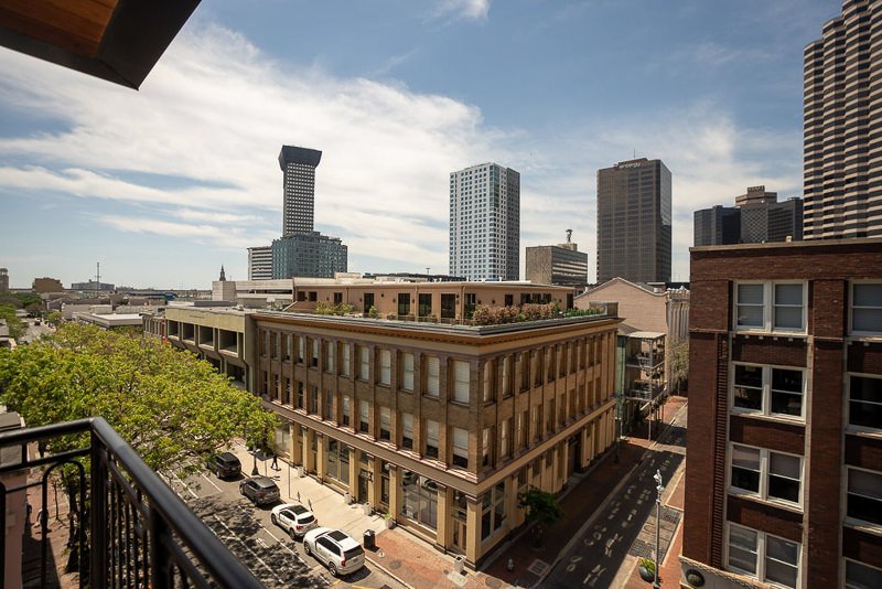 0001_A cityscape with modern buildings and clear skies viewed from a balcony.jpg